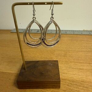 Silver tone tear drop earrings with purple rhinestone accent